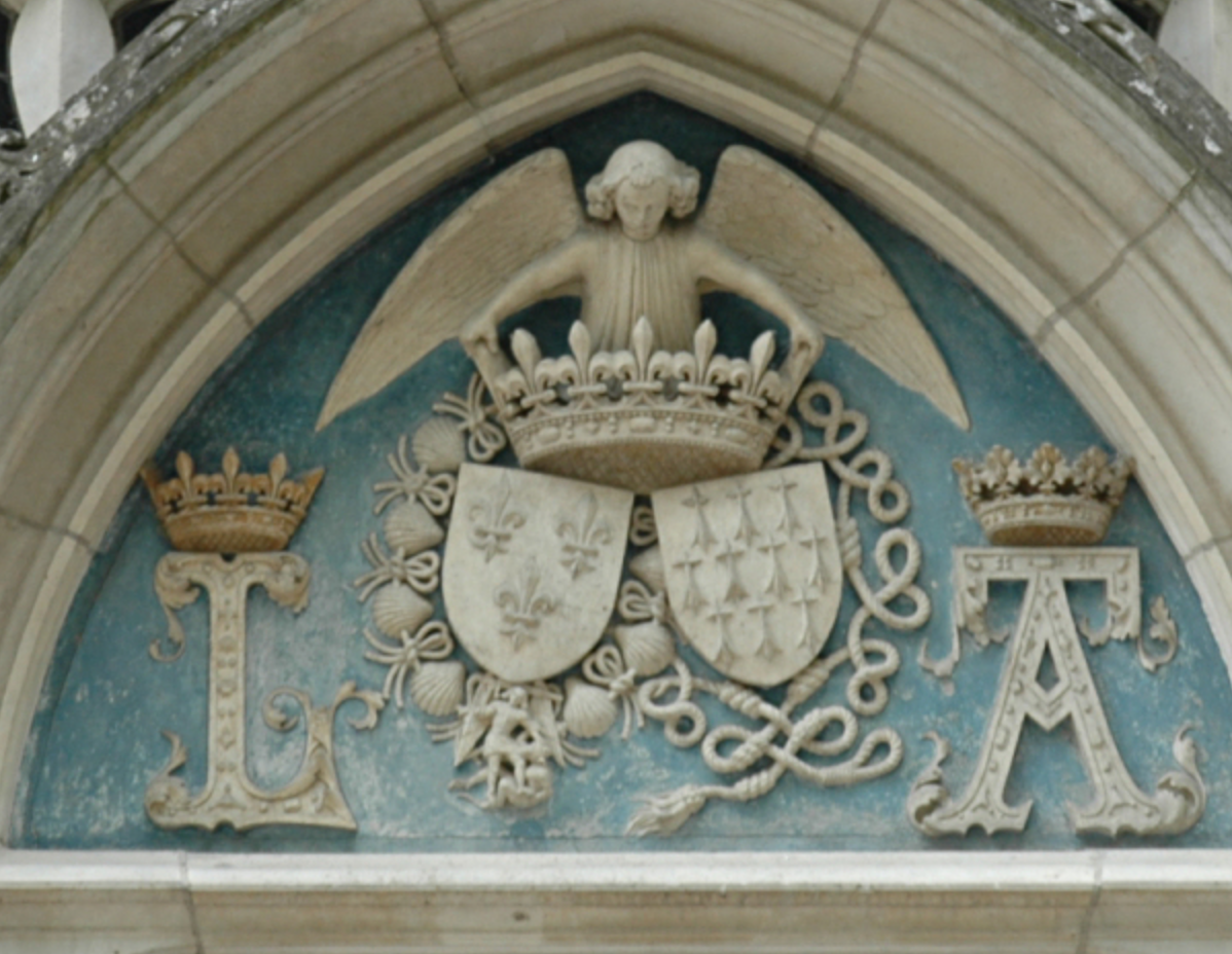 A piece of architecture gable of the chapel's entrance showing crowned initials of Louis XII and Anne with their arms surrounded by the Orders of Saint Michael and the Cord 